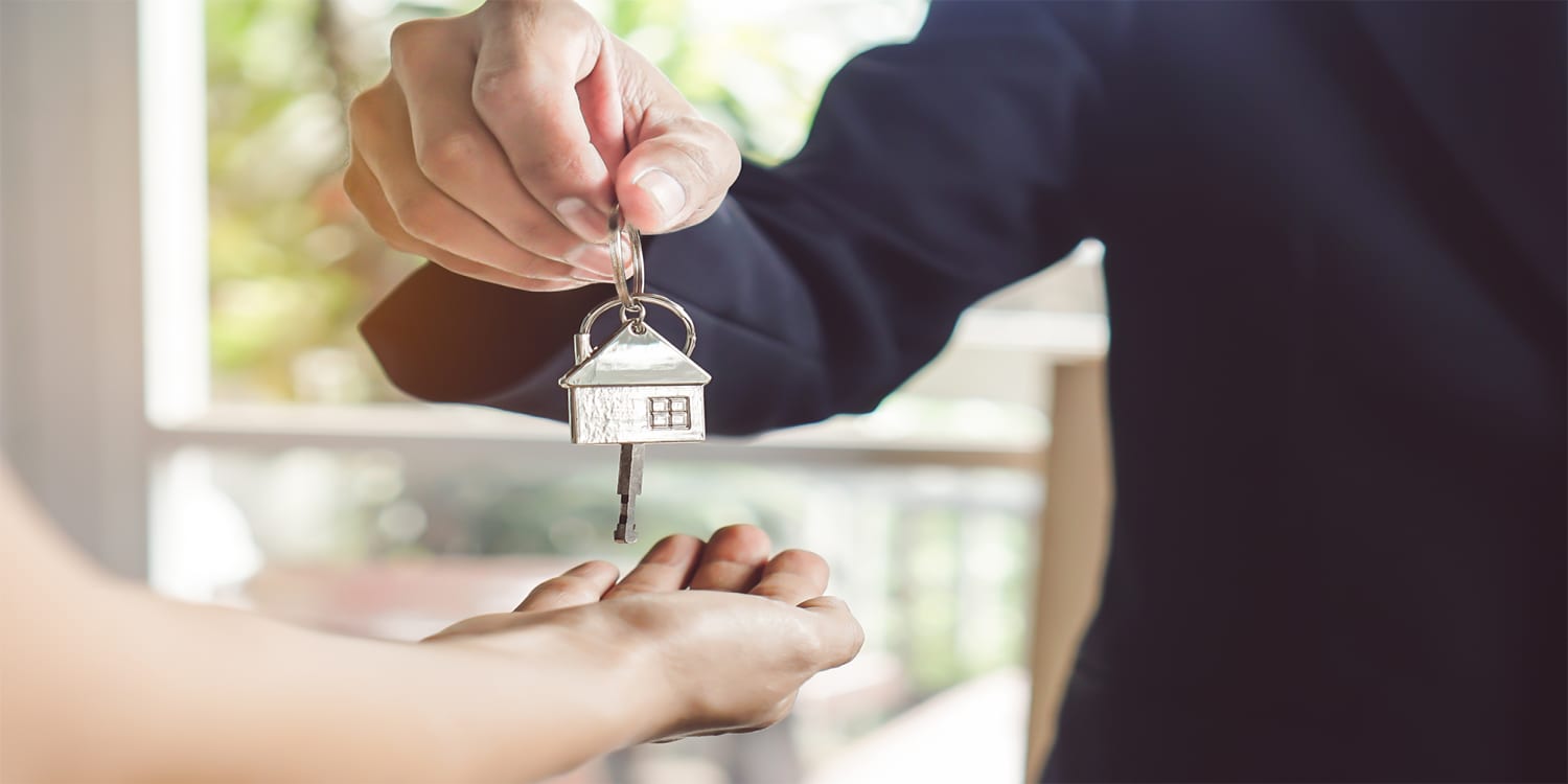 Property manager handing keys over to tenant